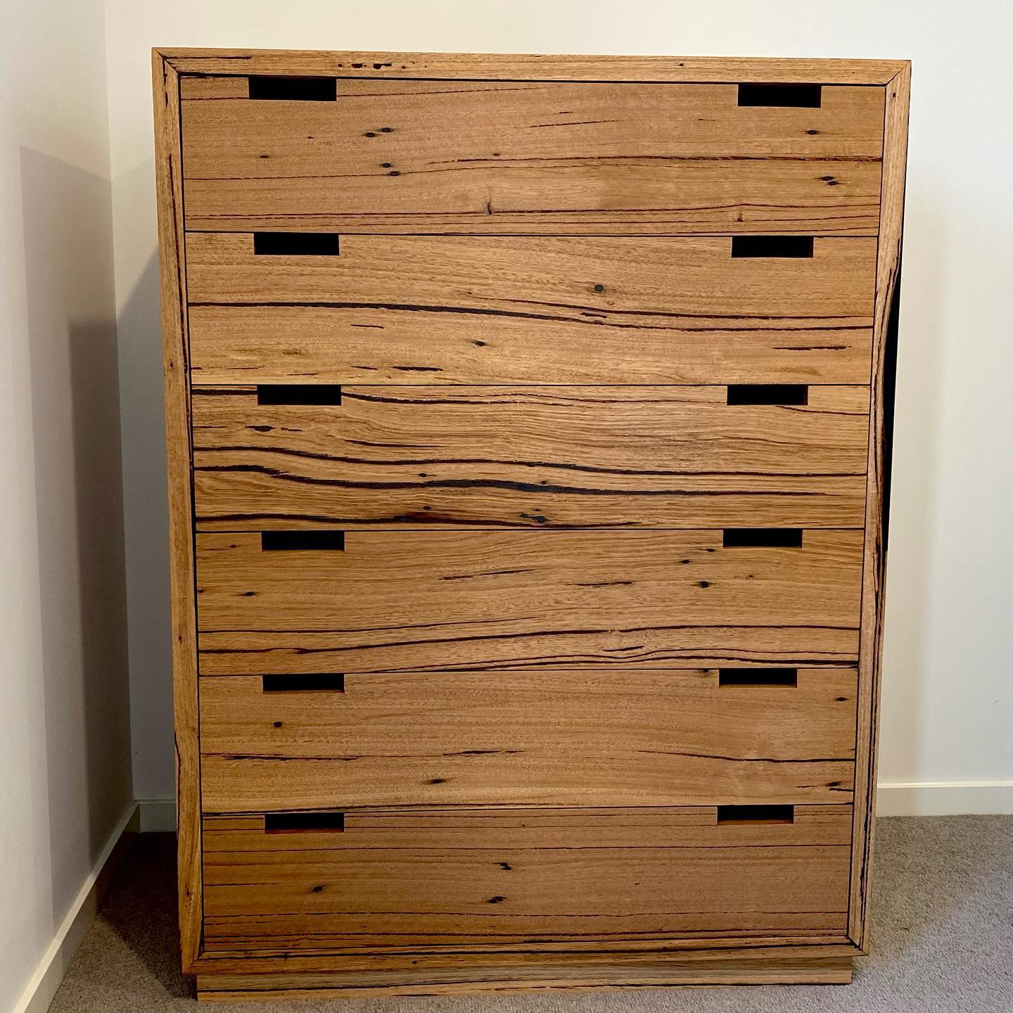 Handcrafted tallboy dresser in Australian hardwood, showcasing seamless drawer design.