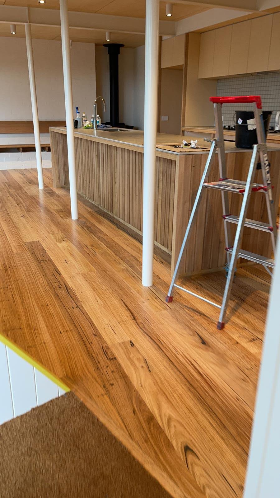 Recycled engineered Australian hardwood flooring installed in a modern kitchen interior with timber accents