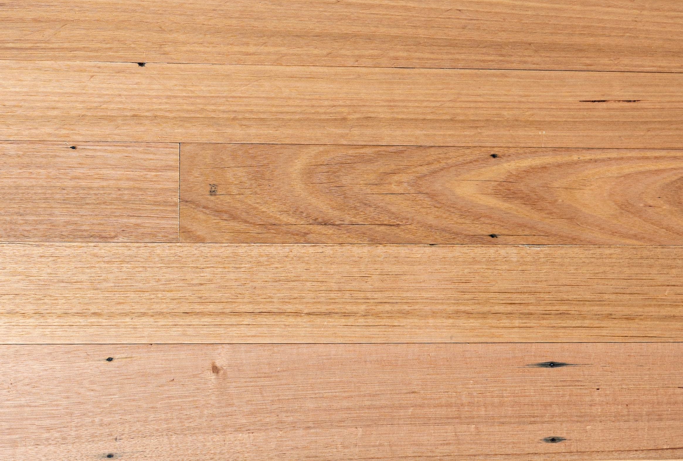 Close-up of engineered timber flooring showing smooth surface, natural grain, and warm brown tones