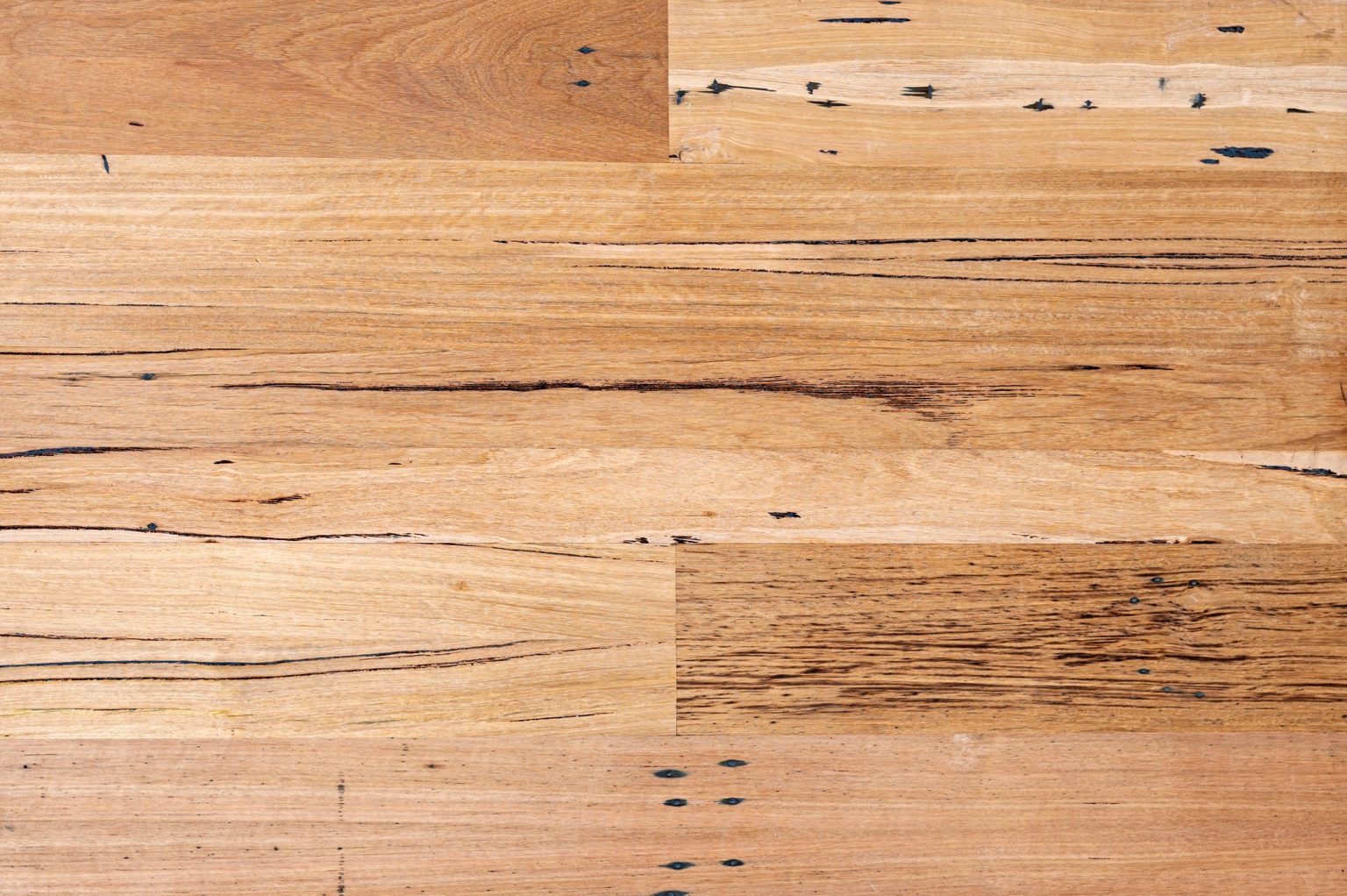 Close-up of solid recycled overlay Australian hardwood flooring showing grain, character marks, and warm natural tones