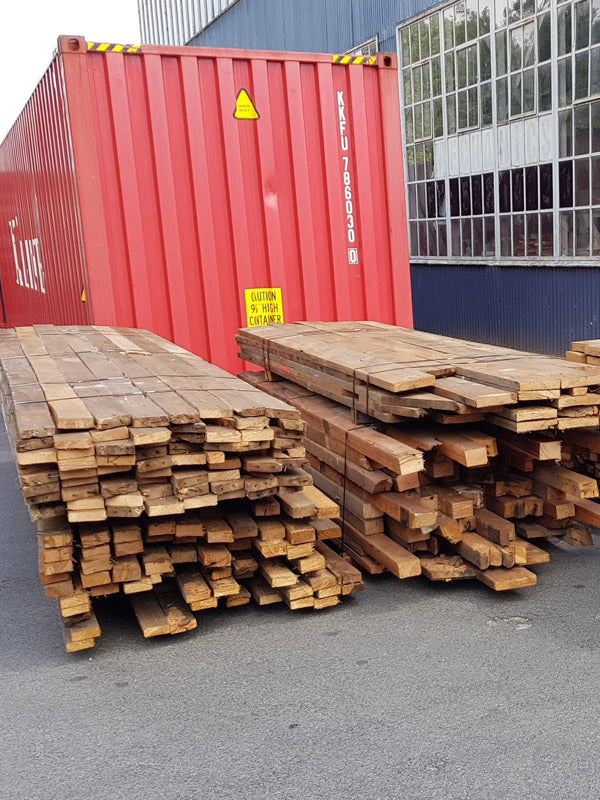 Step 2 of the timber recycling process — reclaimed hardwood being milled and prepared for reconstruction at the processing facility