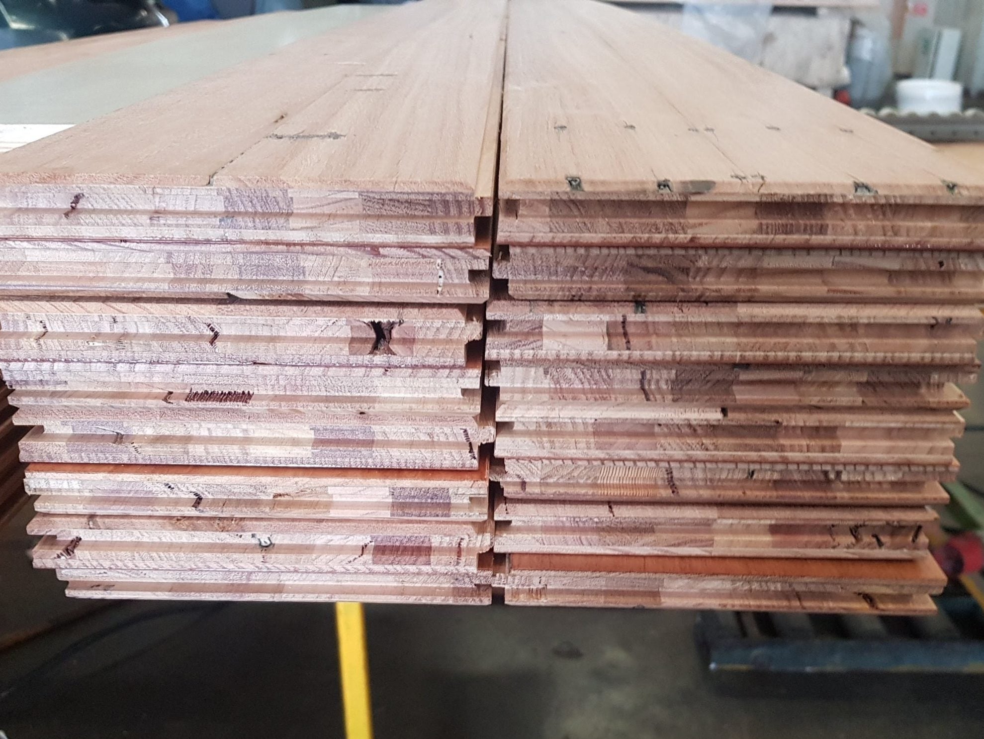 Step 3 of the timber recycling process — reconstructed and profiled engineered hardwood floorboards ready for finishing