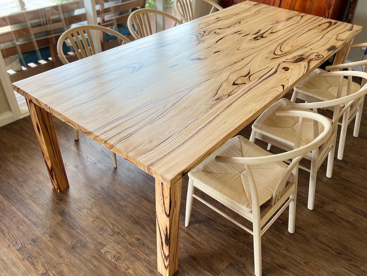 Fairhaven recycled messmate dining table with natural timber grain and wishbone chairs